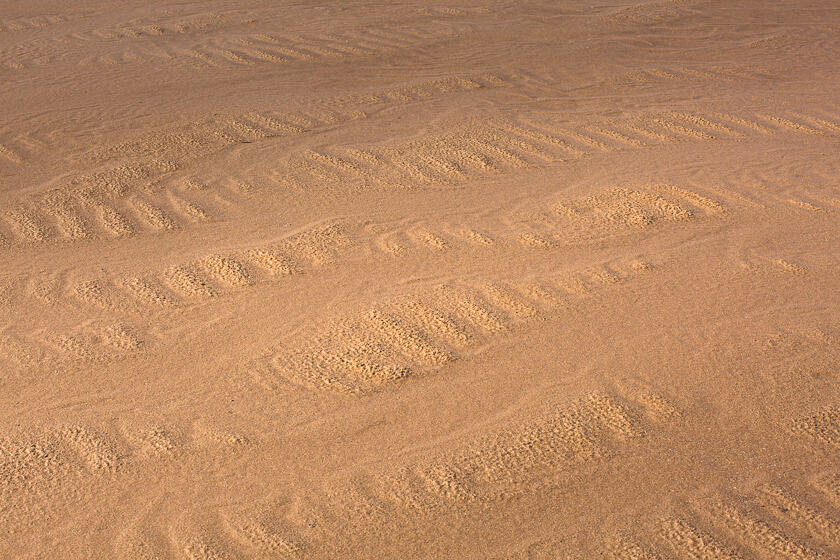 Patterns left in the sand by the retreating tide at Whiteford Sands on the Gower Peninsula, Wales.