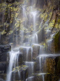 A waterfall cascading over columnar basalt on the Ardmeanach peninsula