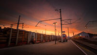 Sunrise at Villach Hauptbahnhof (train station) where a timber laden train waits to set off.